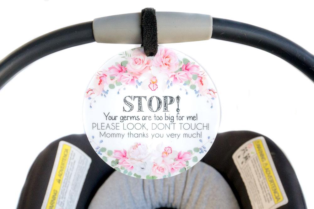 Newborn baby girl flower car seat sign to not touch baby stroller